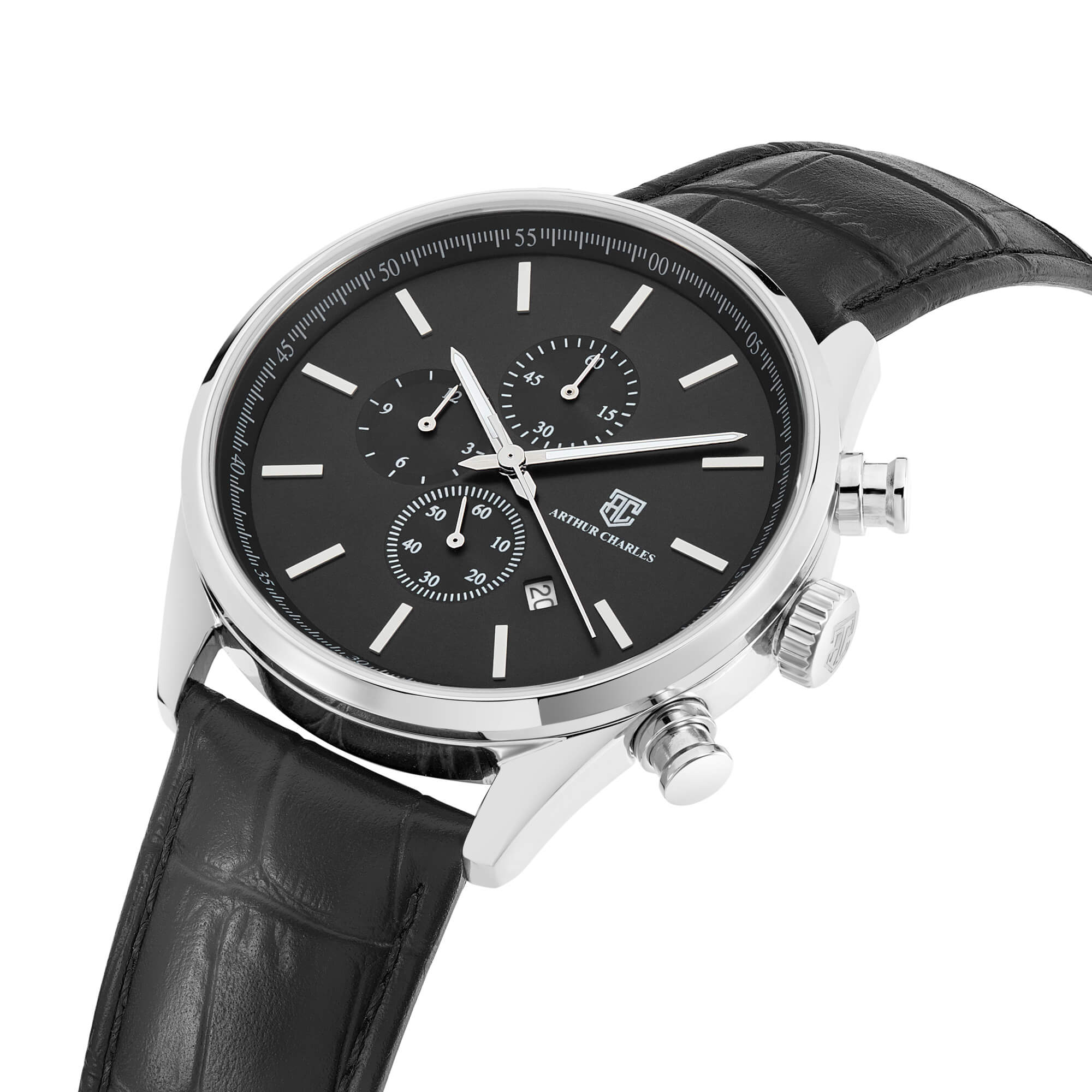 A side view of the Silver Chrono Prestige Watch by Arthur Charles. The Arthur Charles logo is displayed on the front of the watch and the crown. This timepiece features silver chronograph movement and uses a high end genuine leather black strap.